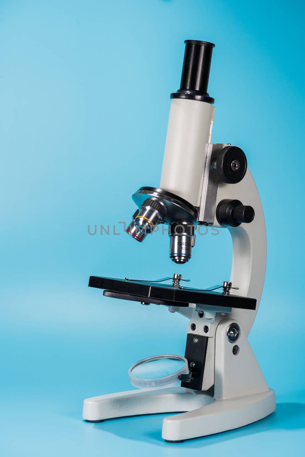 science microscope on light blue background