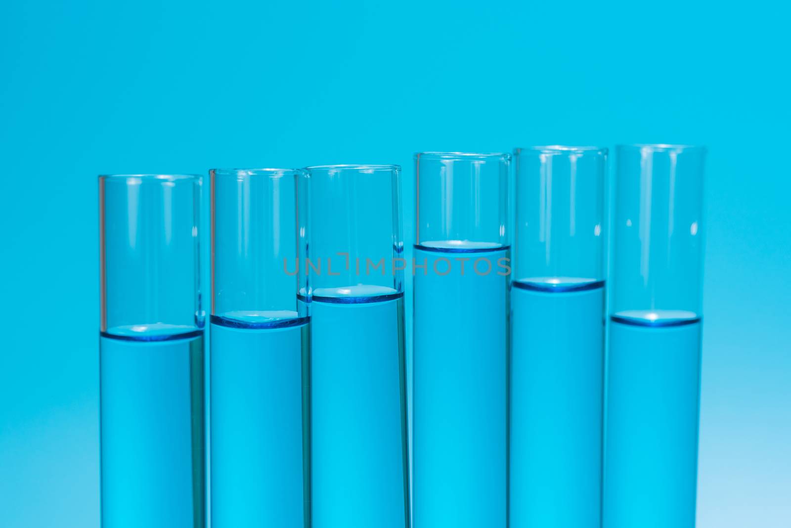 science laboratory test tubes on light blue background , laboratory equipment