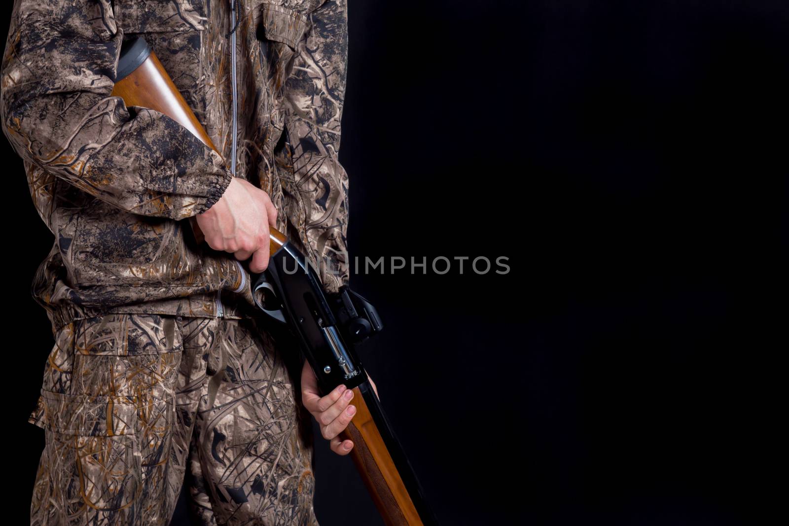 Preparation for spring or autumn hunting. Hunter in camouflage c by YevgeniySam