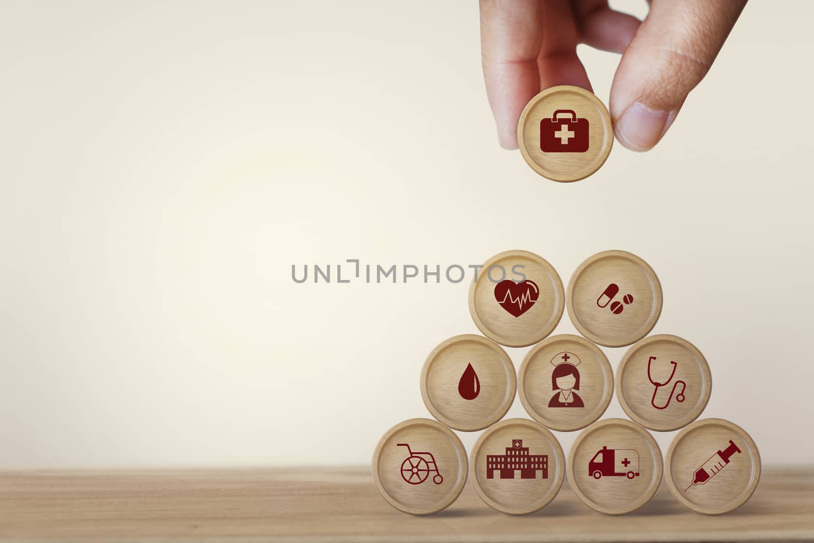 Healthcare concept about of health and medical insurance, Hand arranging block sphere stacking with icon health care medical on table wooden background. by setila