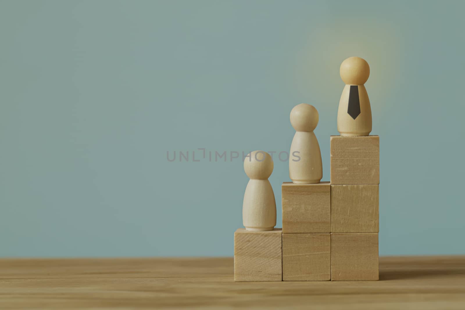 Successful business team leader concept: Businessman standing at the highest point on Wooden block. depicts of career growth up or business success.