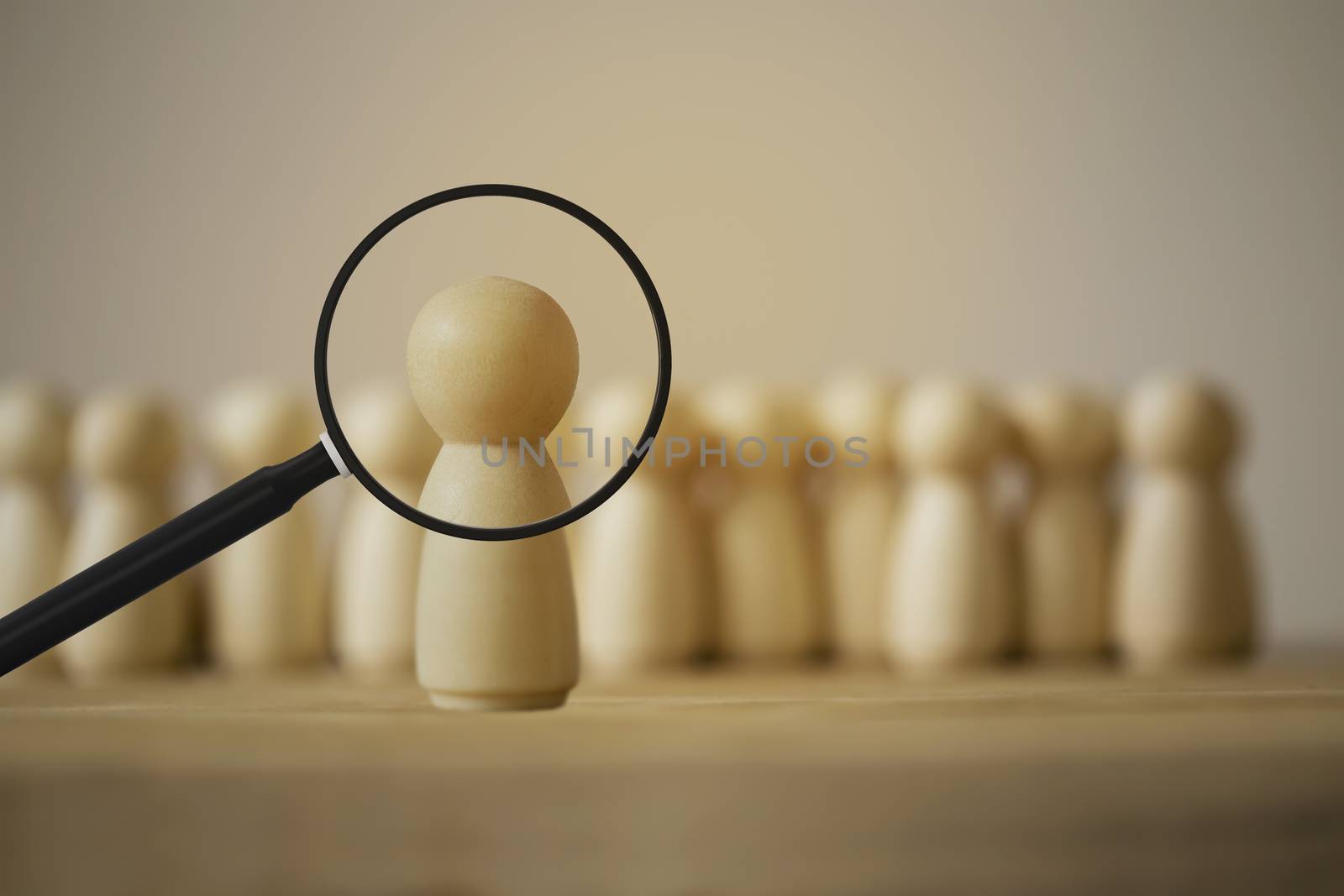 Choosing a good employee leader/leadership concept: Magnifying glass Looking for people model standing out from the crowd.  depicts capability and management towards goals