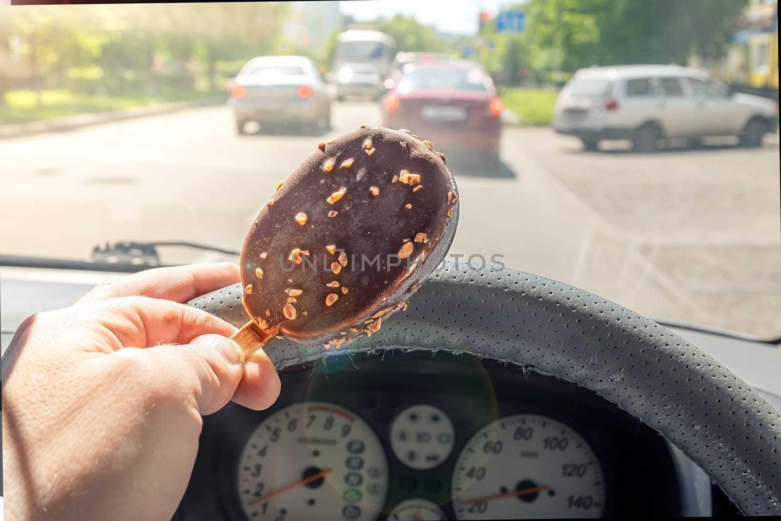 the driver holds the ice cream while driving a car by jk3030