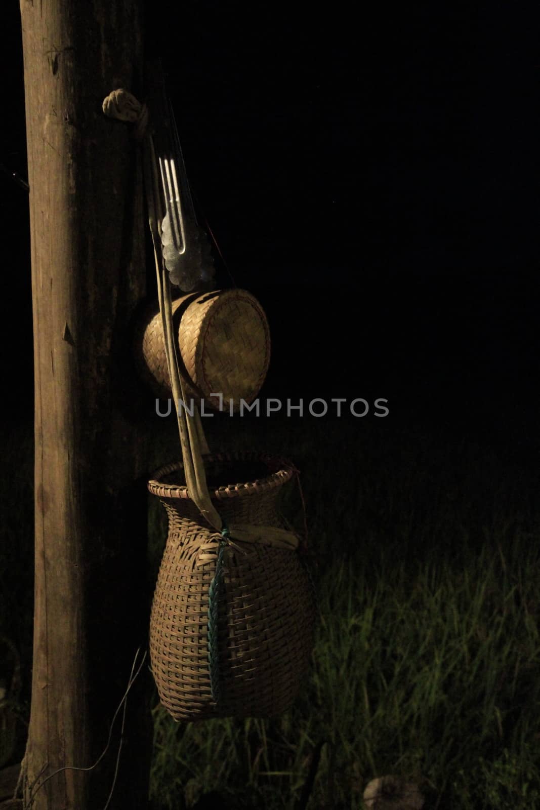 Hanging fish container attached to the house post.