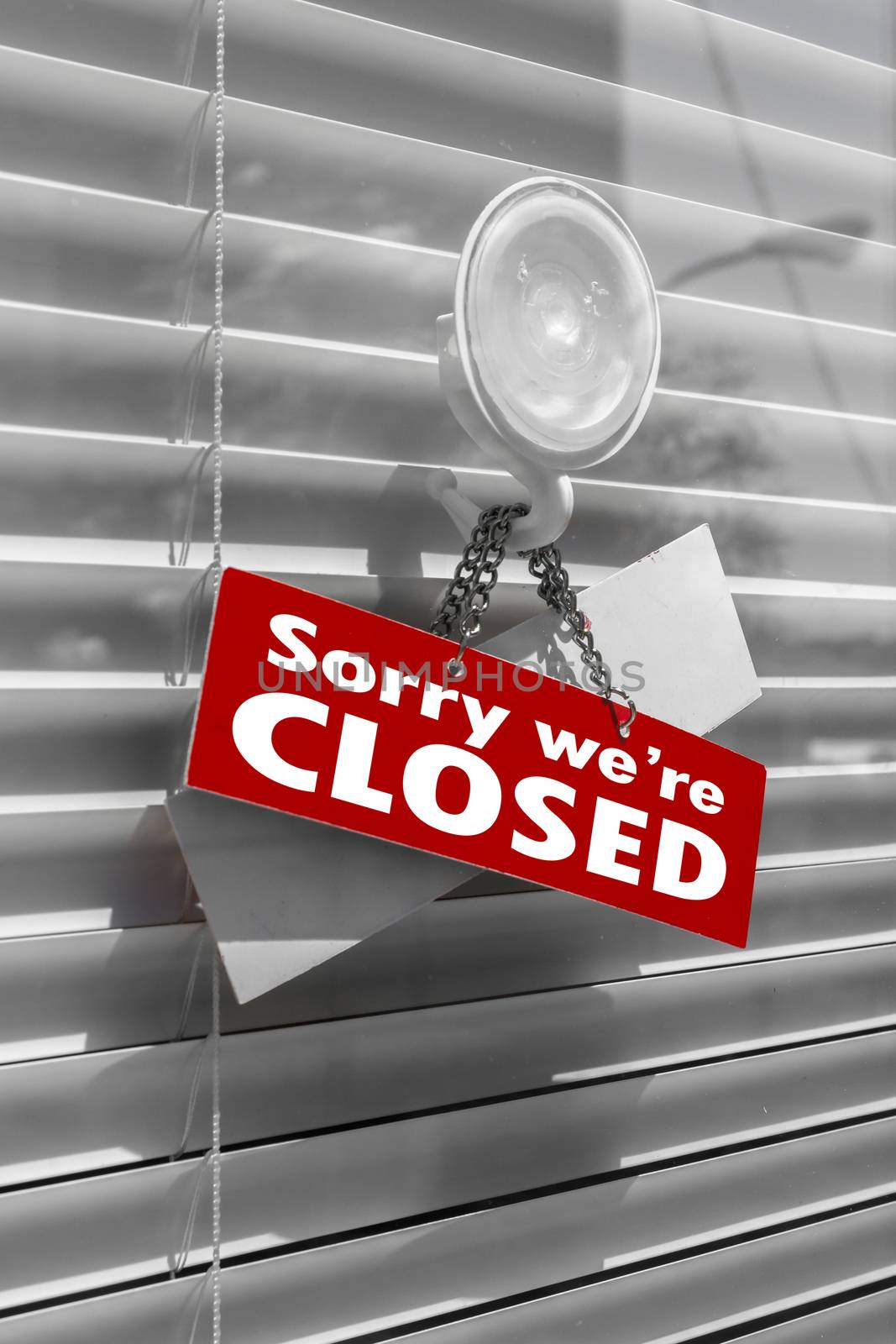 Closed Sign on a door with venetian blind