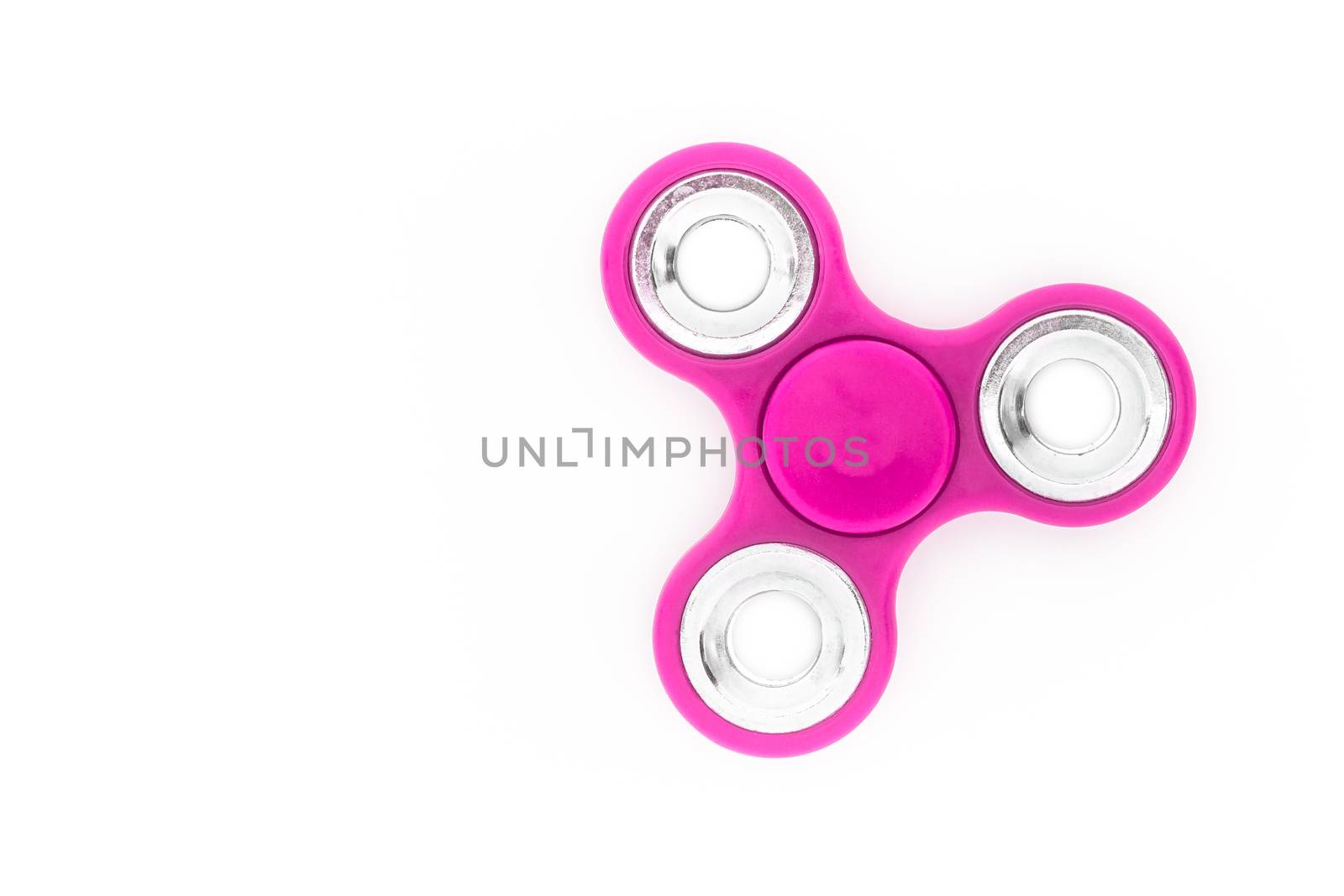 Pink finger spinner (stress anxiety relief toy) isolated on white background.