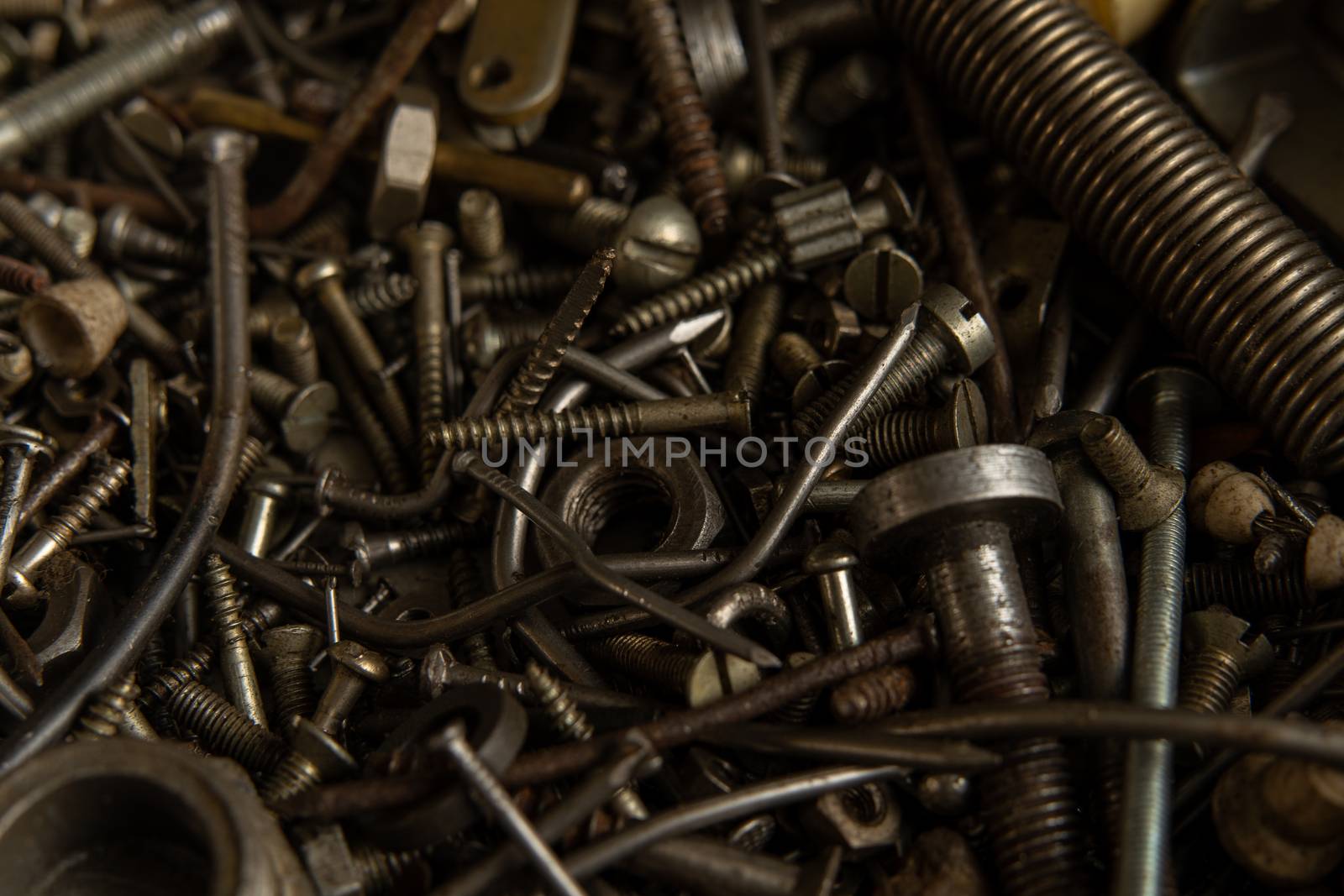 Range Rusty old screws bolts nuts. Grunge metal Hardware details dark nackground