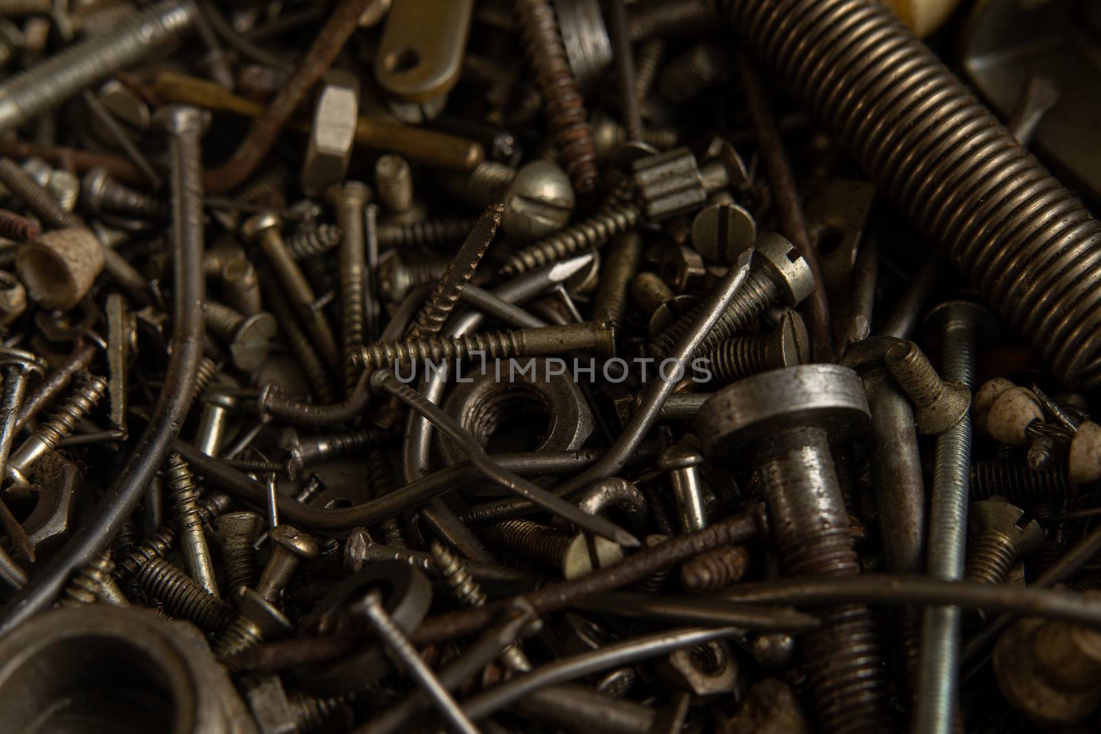 Range Rusty old screws bolts nuts. Grunge metal Hardware details by andreonegin