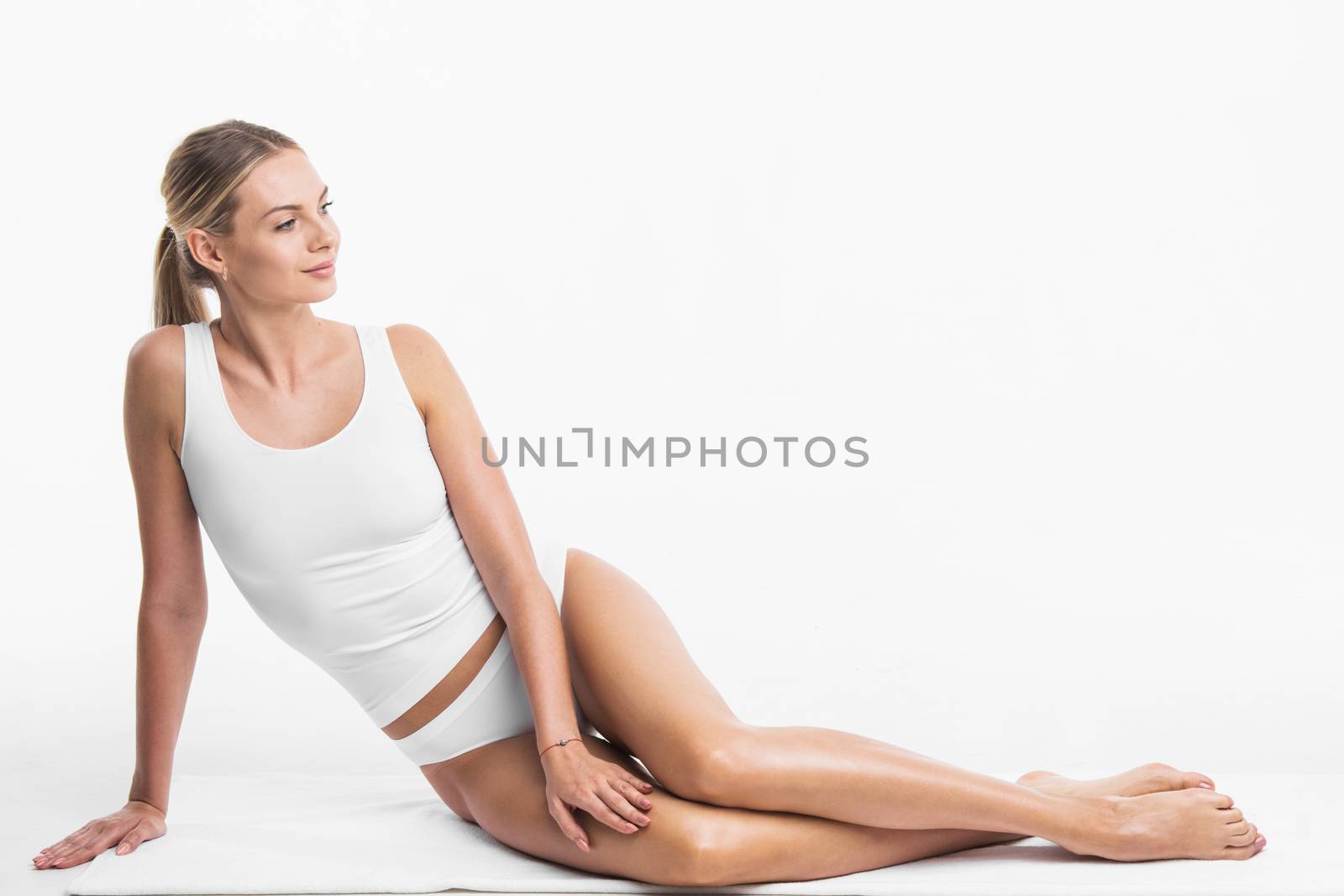 Attractive sensitive slim woman sitting in white cotton lingerie underwear isolated on white background