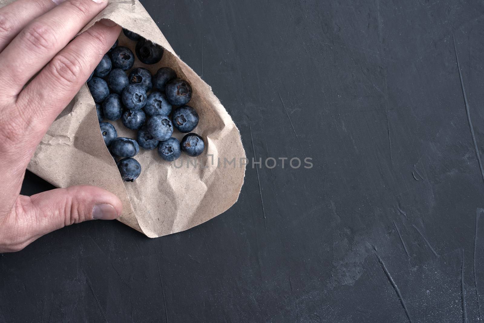 Blueberry antioxidant organic superfood in a paper packaging concept for healthy eating and dieting nutrition Top view.