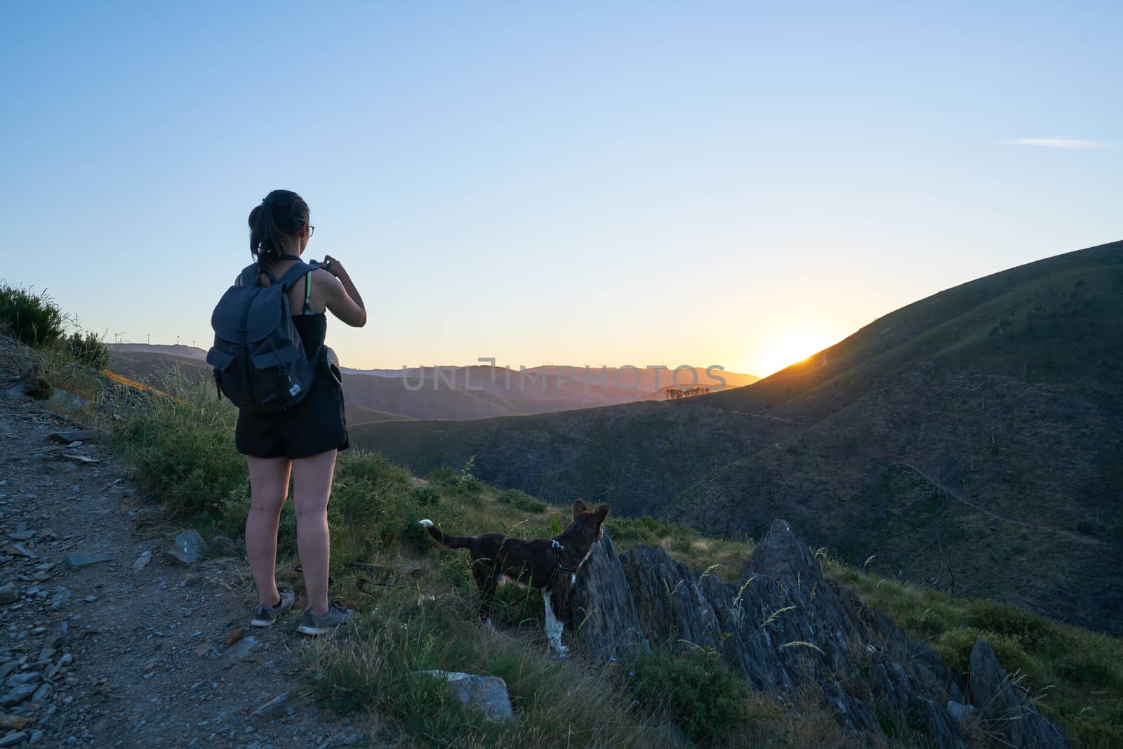 Woman girl with dog in Serra da Freita landscape panoramic view in Arouca at sunset, Portugal by Luispinaphotography