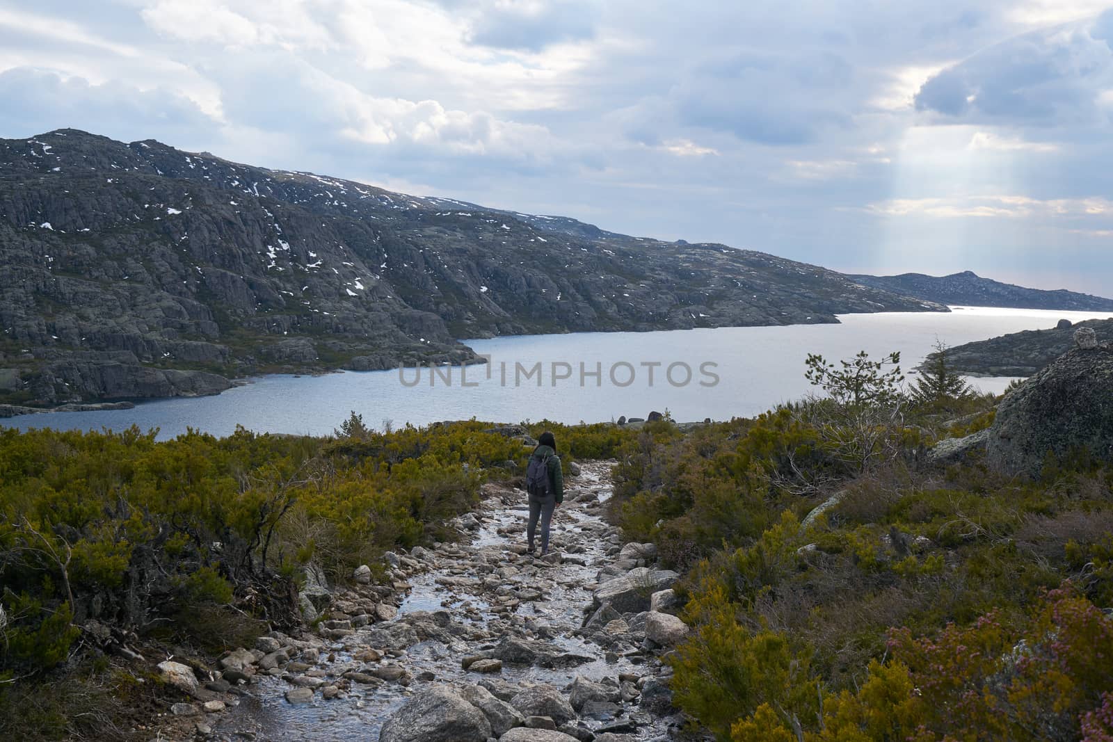 Woman girl hiking landscape in lake Lagoa comprida lagoon in Serra da Estrela, Portugal