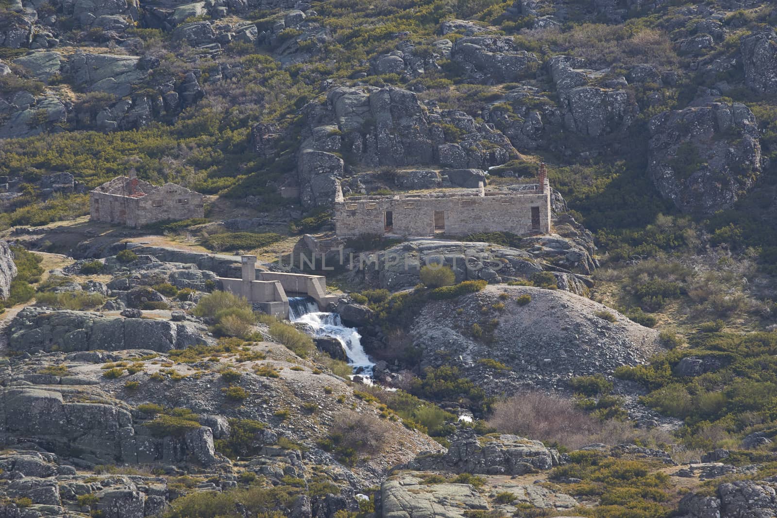 Landscape of Serra da Estrela with abandoned building and a waterfall in lagoons route, in Portugal by Luispinaphotography