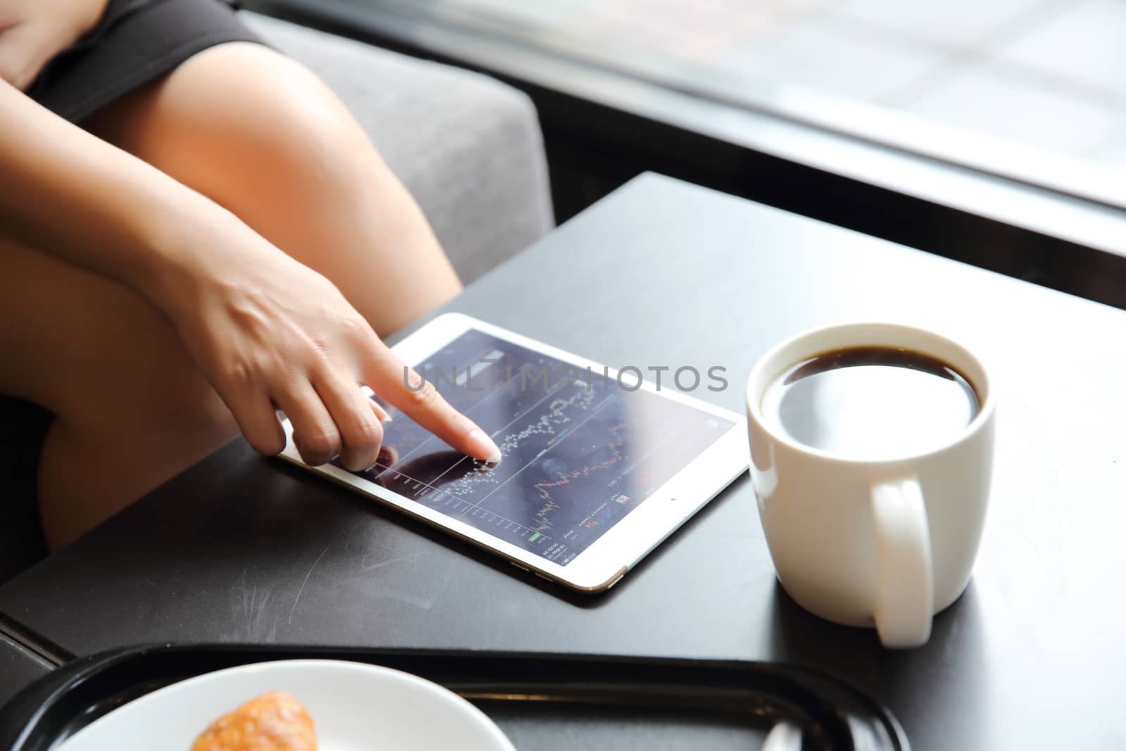 bussiness woman with tablet for bussiness in coffee shop by piyato