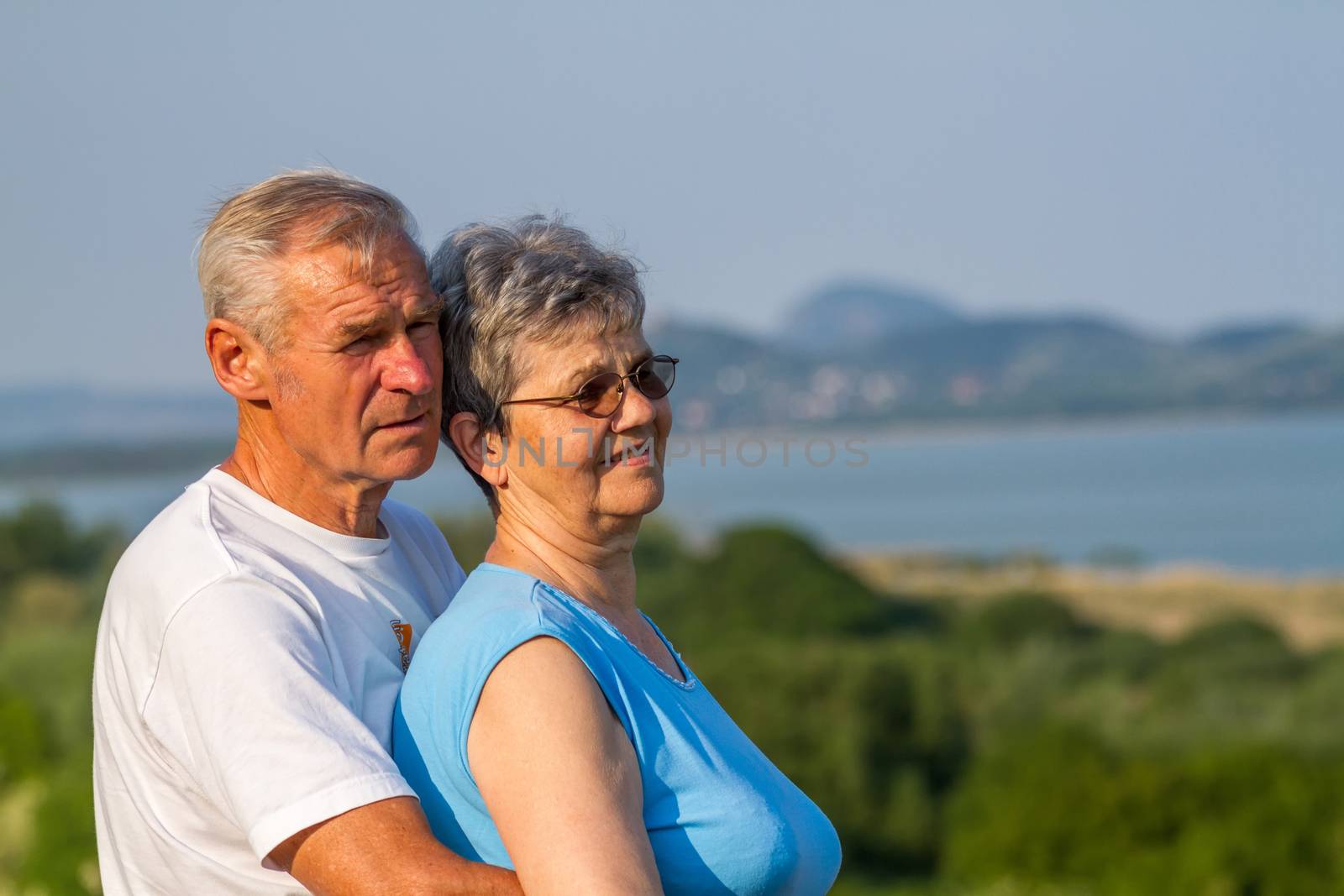 Seniors couple in outdoors by Digoarpi
