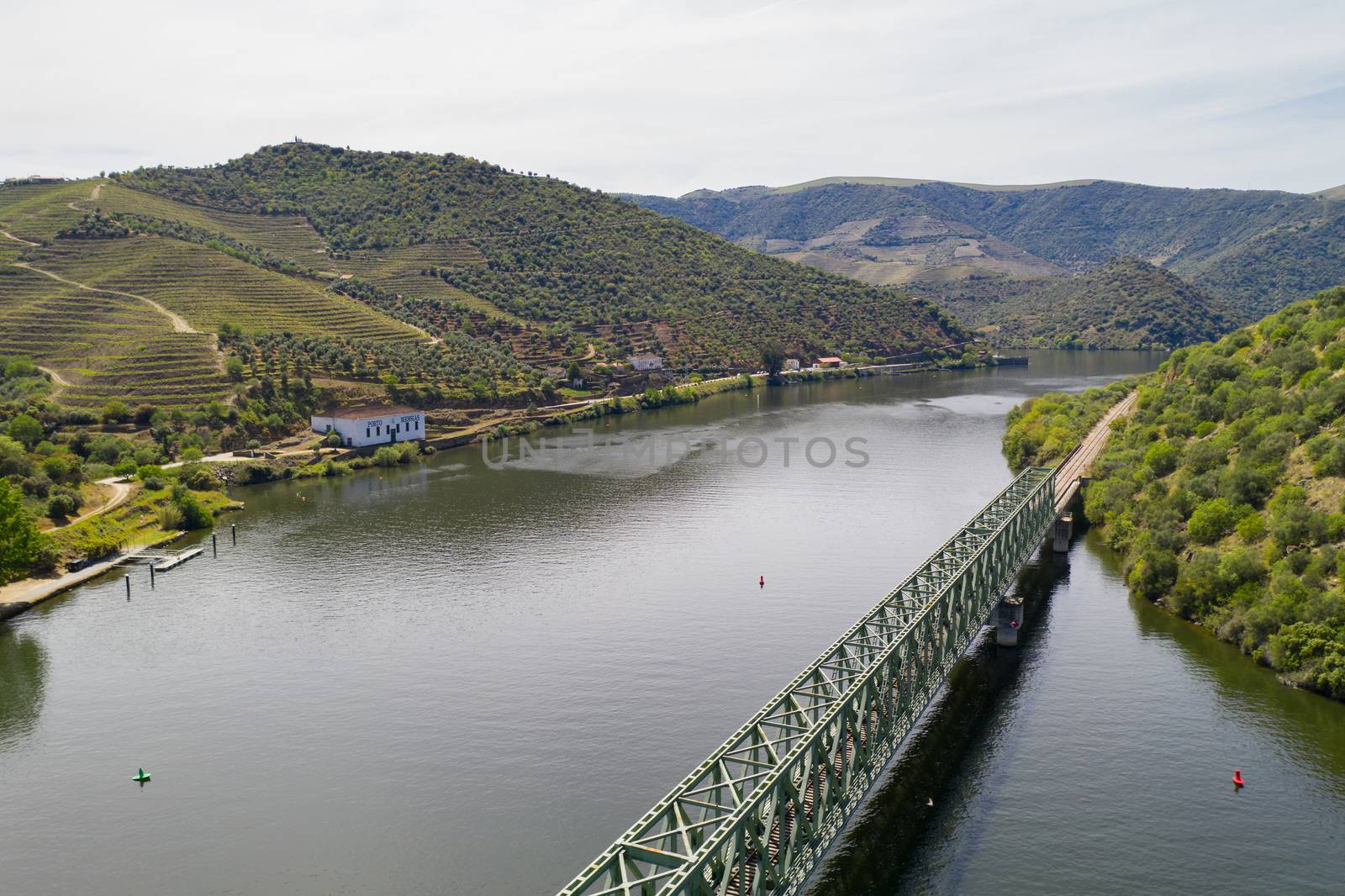 Douro railway bridge drone aerial view of river wine region in Ferradosa, Portugal by Luispinaphotography