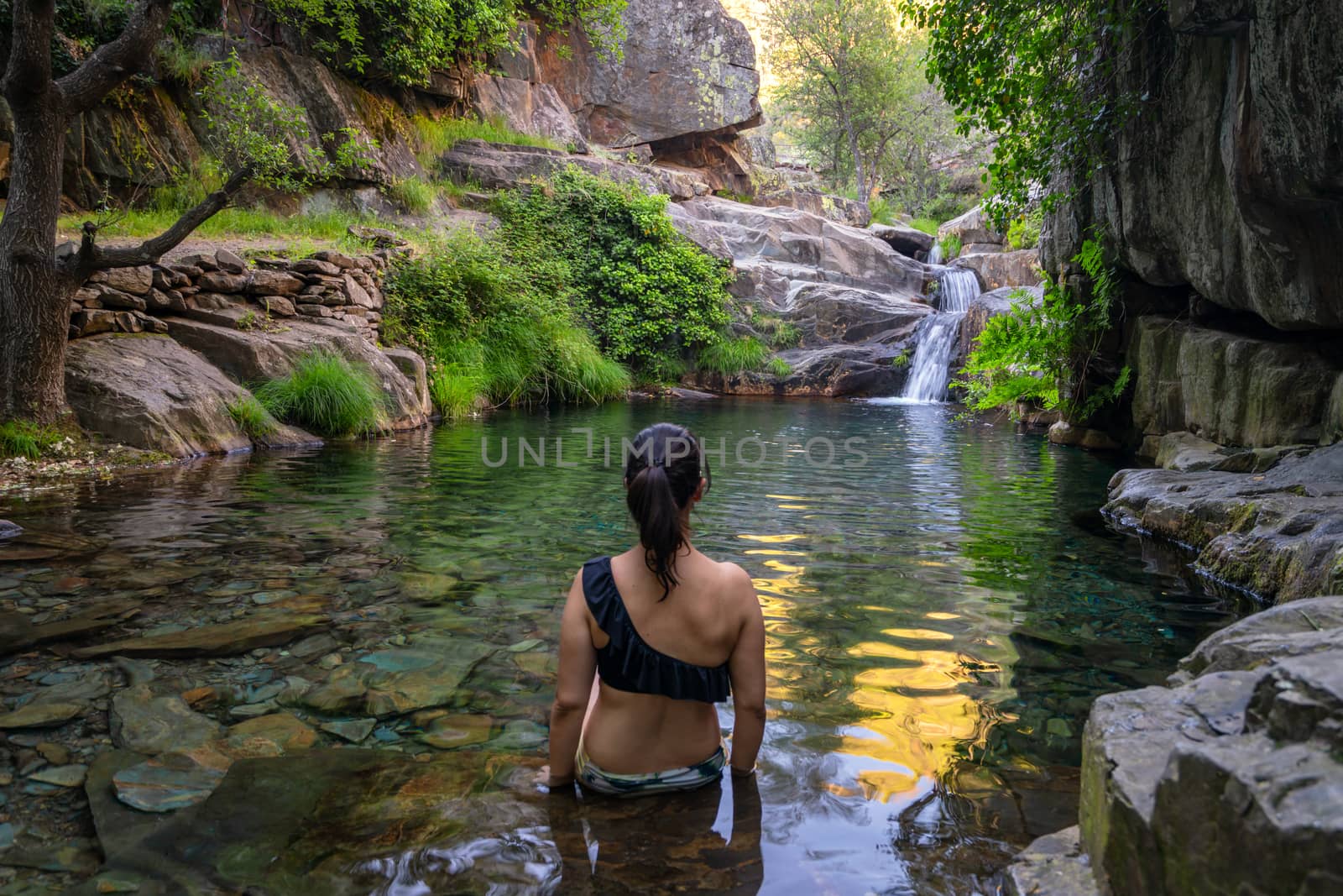 Woman in Drave waterfall cascata in Arouca Serra da Freita, Portugal by Luispinaphotography