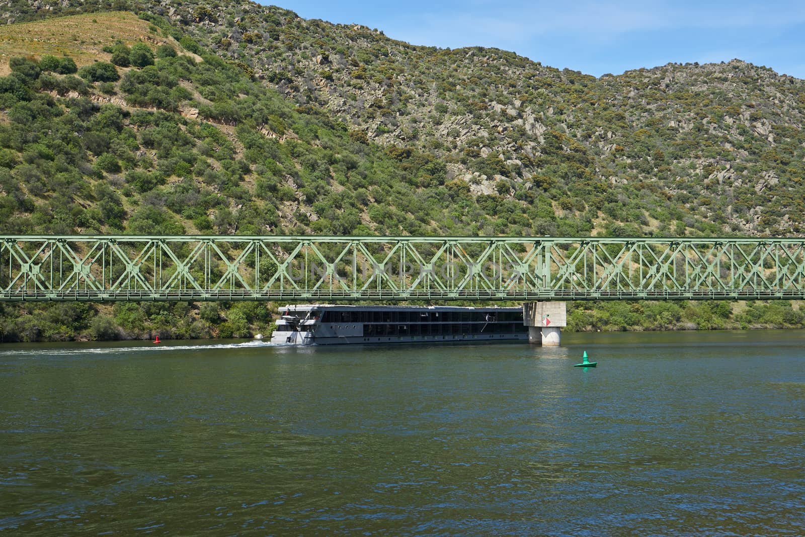 Boats passing on railway bridge in Douro region in Ferradosa, Portugal