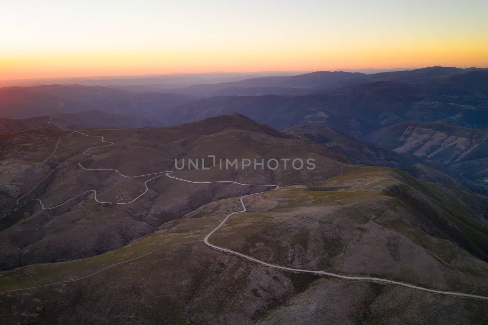 Serra da Freita drone aerial view in Arouca Geopark road with wind turbines at sunset, in Portugal