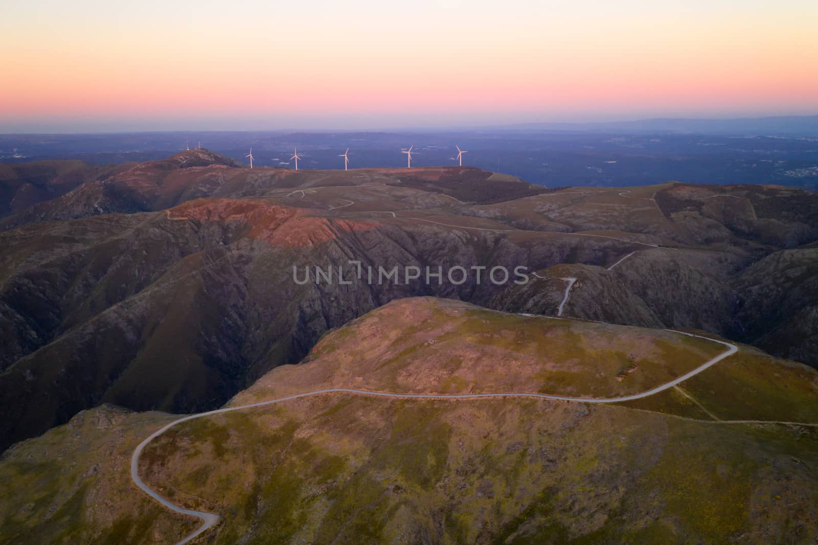 Serra da Freita drone aerial view in Arouca Geopark road with wind turbines at sunset, in Portugal