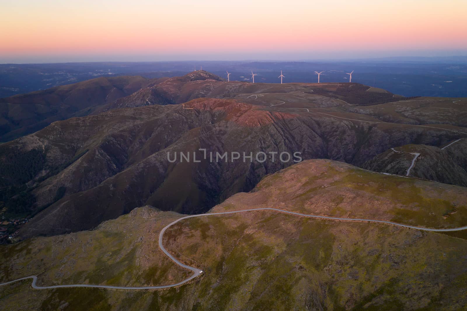 Serra da Freita drone aerial view in Arouca Geopark road with wind turbines at sunset, in Portugal