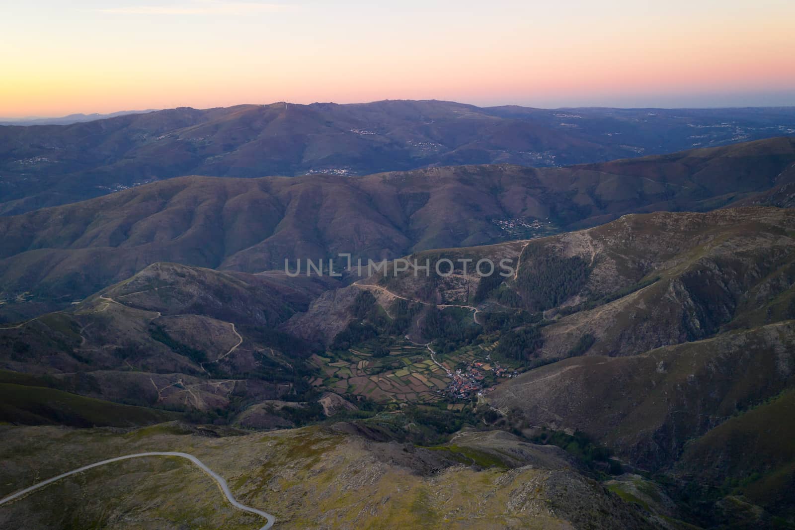 Serra da Freita drone aerial view in Arouca Geopark road with wind turbines at sunset, in Portugal by Luispinaphotography