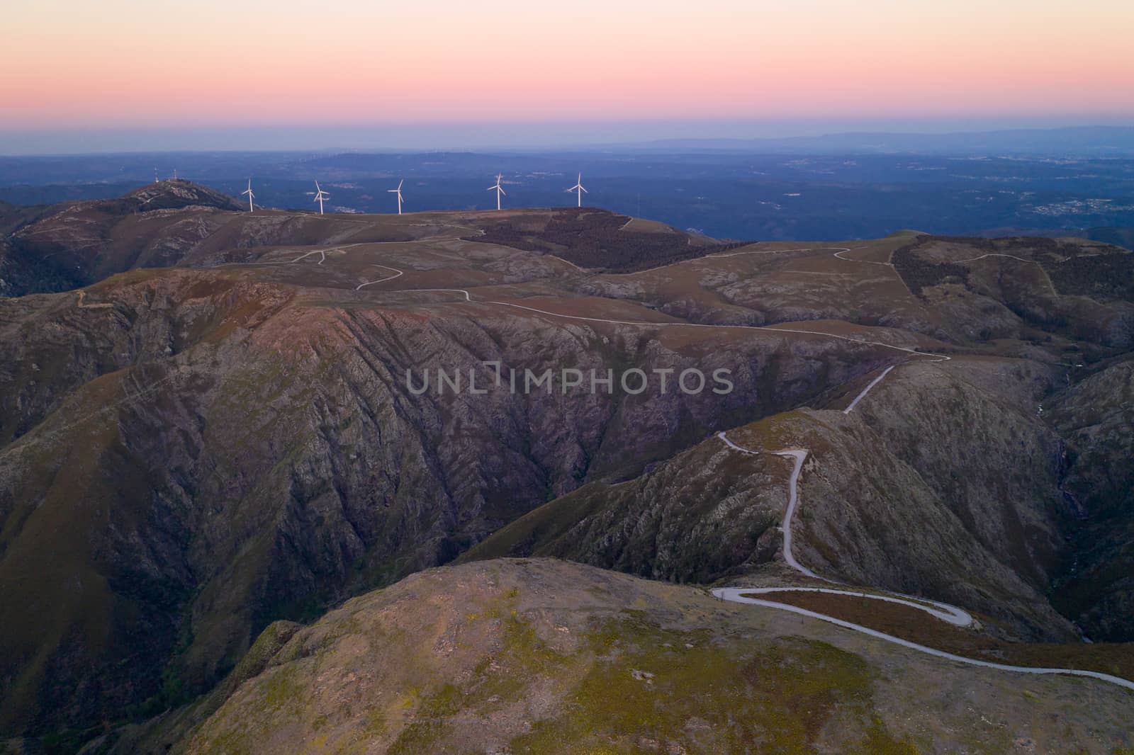 Serra da Freita drone aerial view in Arouca Geopark road with wind turbines at sunset, in Portugal by Luispinaphotography