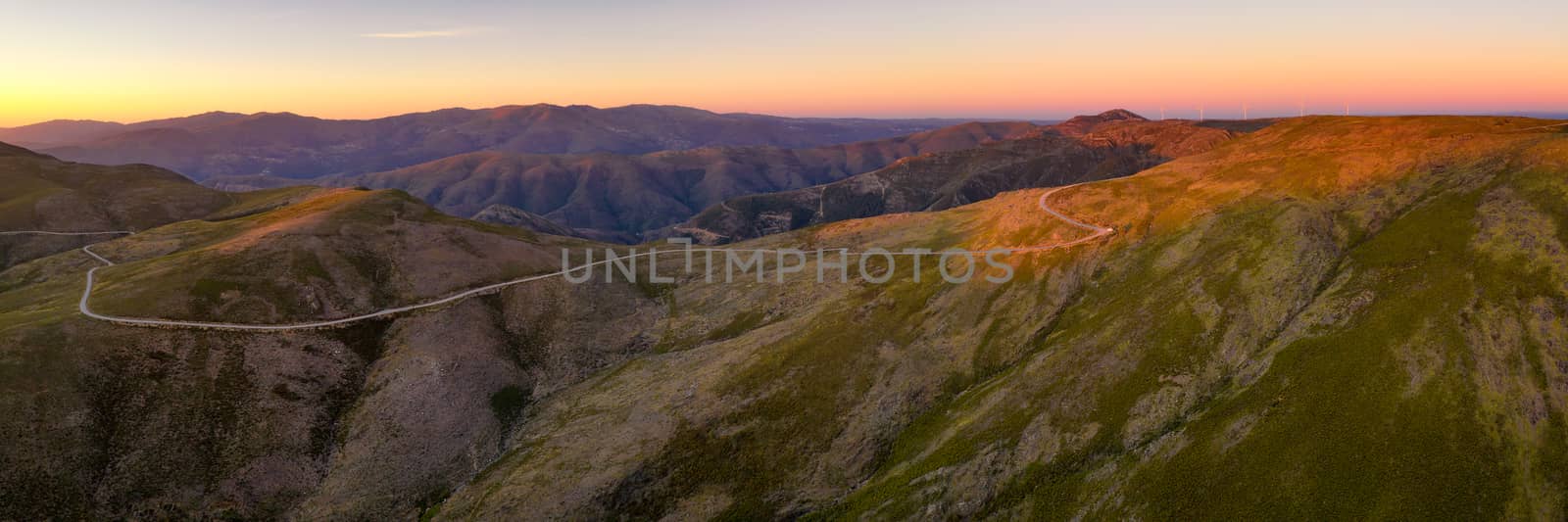 Serra da Freita drone aerial panorama view in Arouca Geopark road with wind turbines at sunset, in Portugal by Luispinaphotography