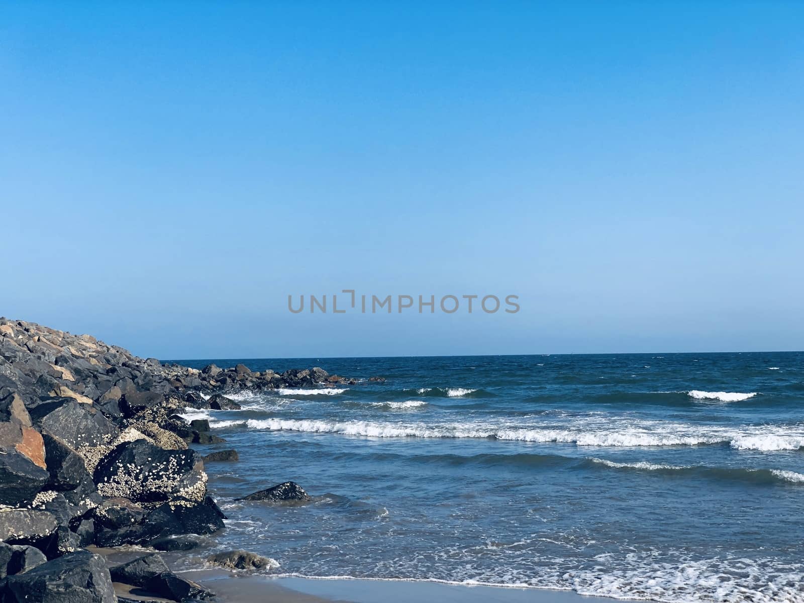 Sea waves on the beach with rocks on the shore at Ennore beach, Tamil nadu by prabhakaran851