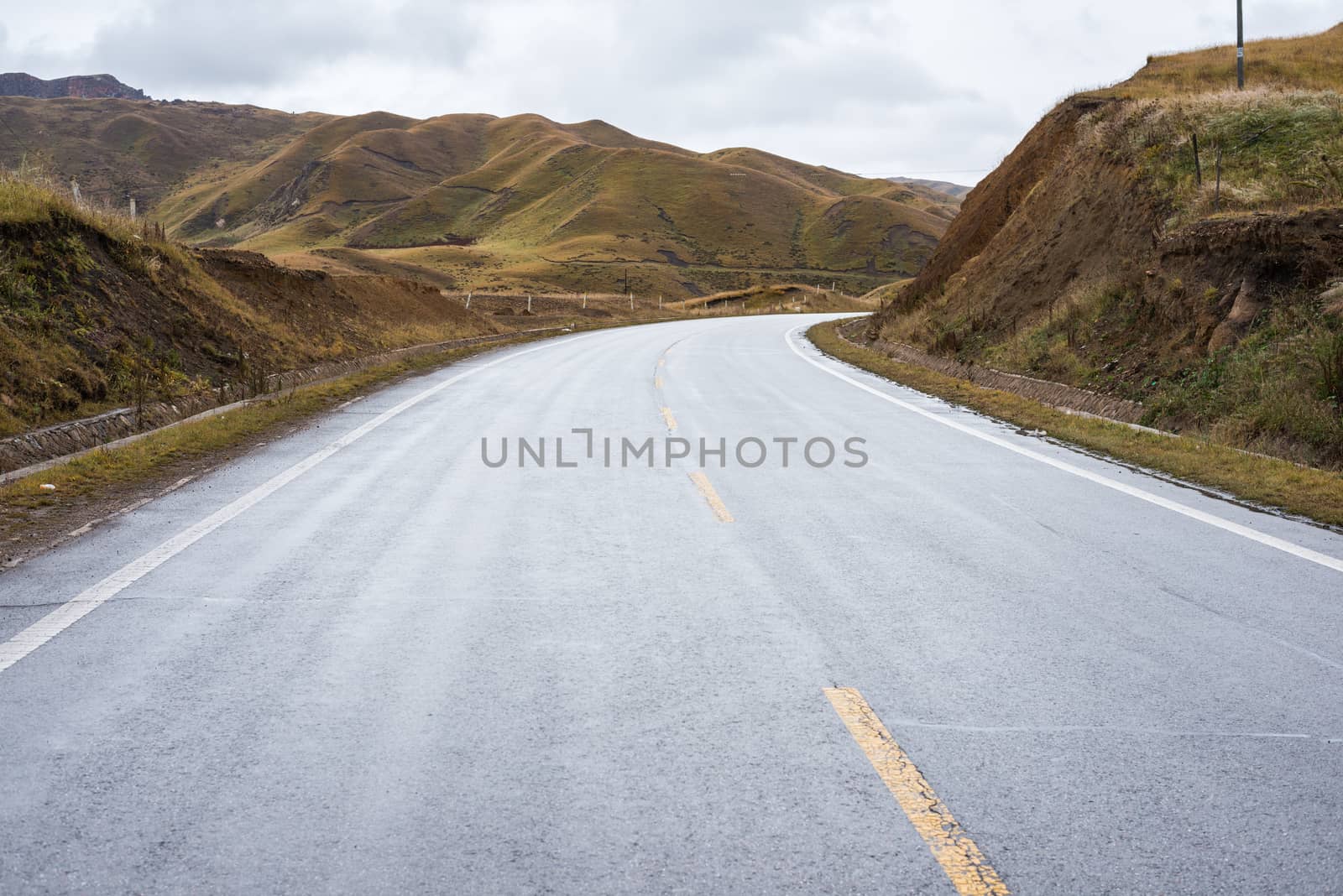 An empty road across barren hills of upper Tibet region by nemo269