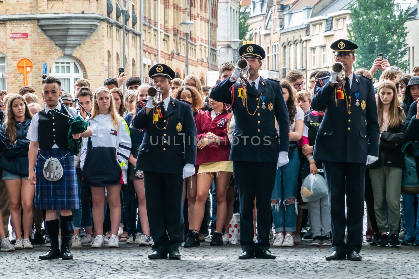 Diksmuide, Flanders, Belgium -  June 19, 2019: Historic Menin Gate. Last Post performance by four men musicians. Rows of English school girls in back.