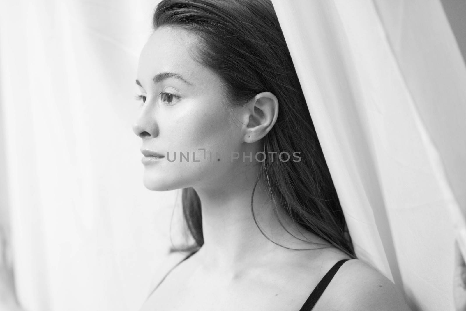 woman at window and curtain front happy face indoor by timwit