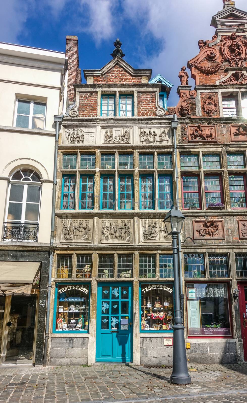 Gent, Flanders, Belgium -  June 21, 2019: Historic small shop on Kraanlei houses Confectioner Temmerman. authentic candy of a previous era. Six of Matthew Works of Mercy sculptures in facade.