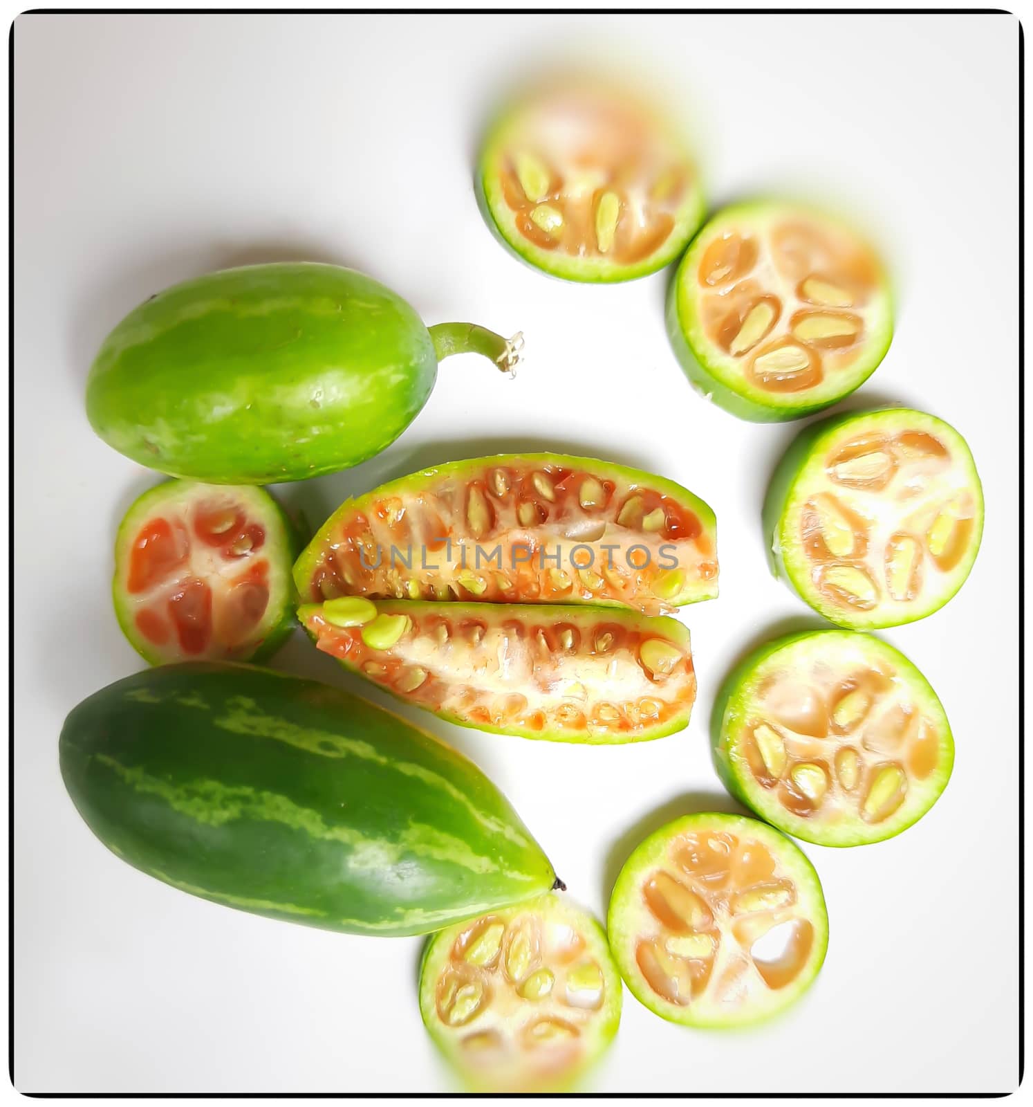 fresh scarlet gourd and it cut into pieces round and vertical shape in white plate dietary supplement and prevent high cholesterol to high blood pressure