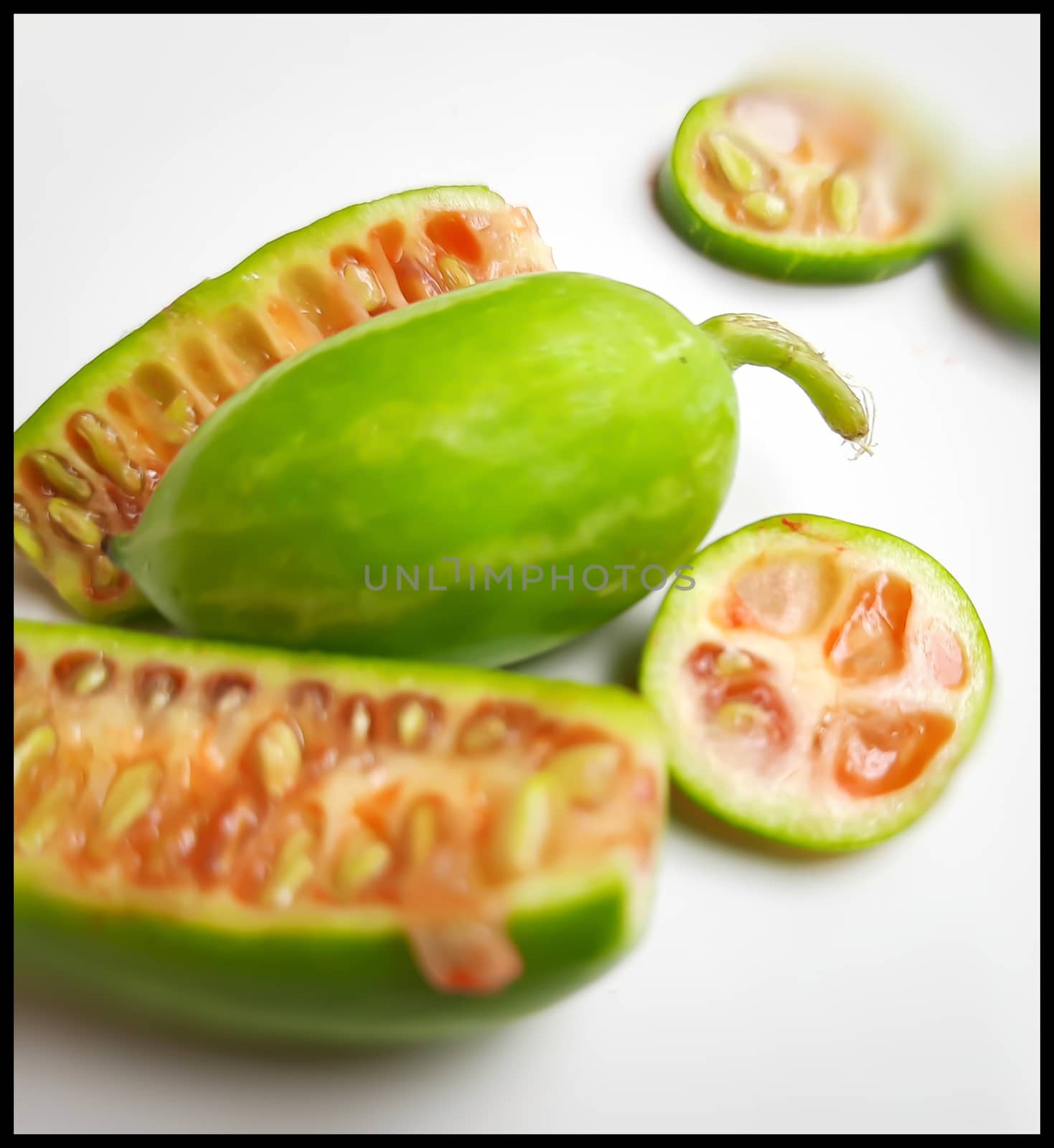 fresh scarlet gourd and it cut into pieces round and vertical shape in white plate dietary supplement and prevent high cholesterol to high blood pressure