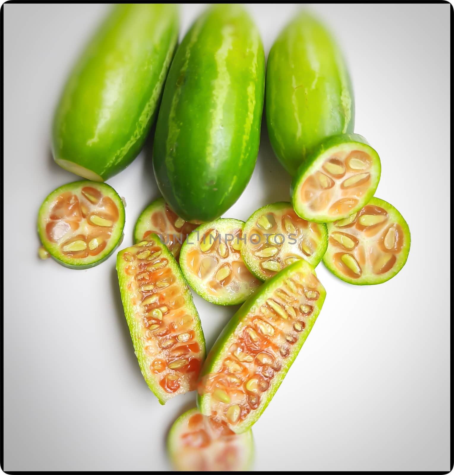 fresh scarlet gourd and it cut into pieces round and vertical shape in white plate dietary supplement and prevent high cholesterol to high blood pressure