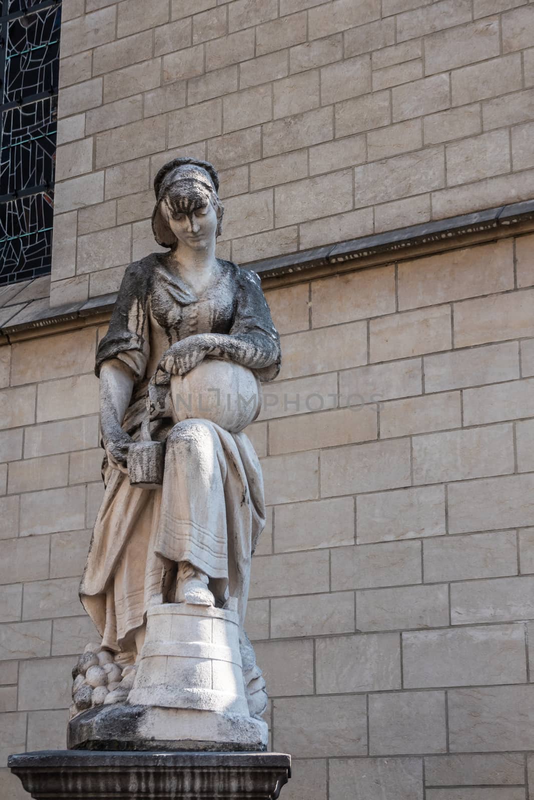 Milkmaid statue outside Saint Nicolas Church, Brussels Belgium. by Claudine