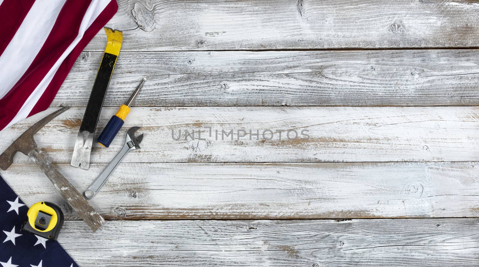 US Happy Labor Day concept with national flag and work tools on white rustic wooden background 