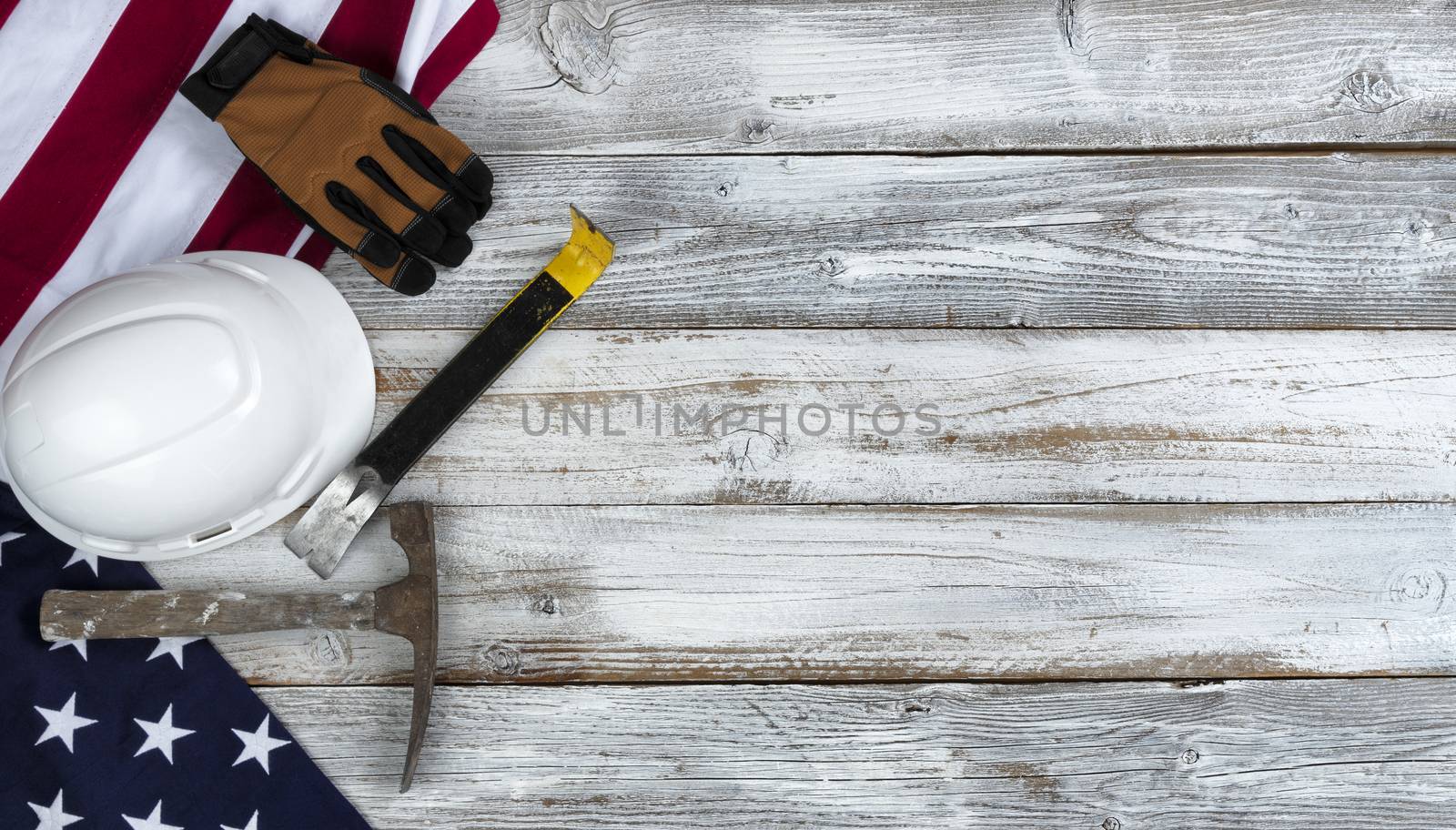 US Happy Labor Day concept with national flag and industrial work tools on white rustic wooden background 