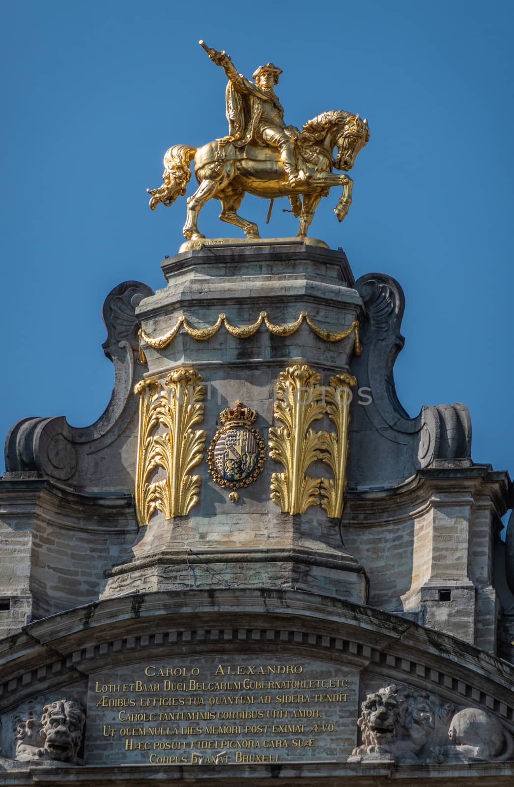 Brussels, Belgium - June 22, 2019: Closeup of golden statue of Charles Alexander of Lorraine on top of L’Arbre D’Or house on Grand place against blue sky.