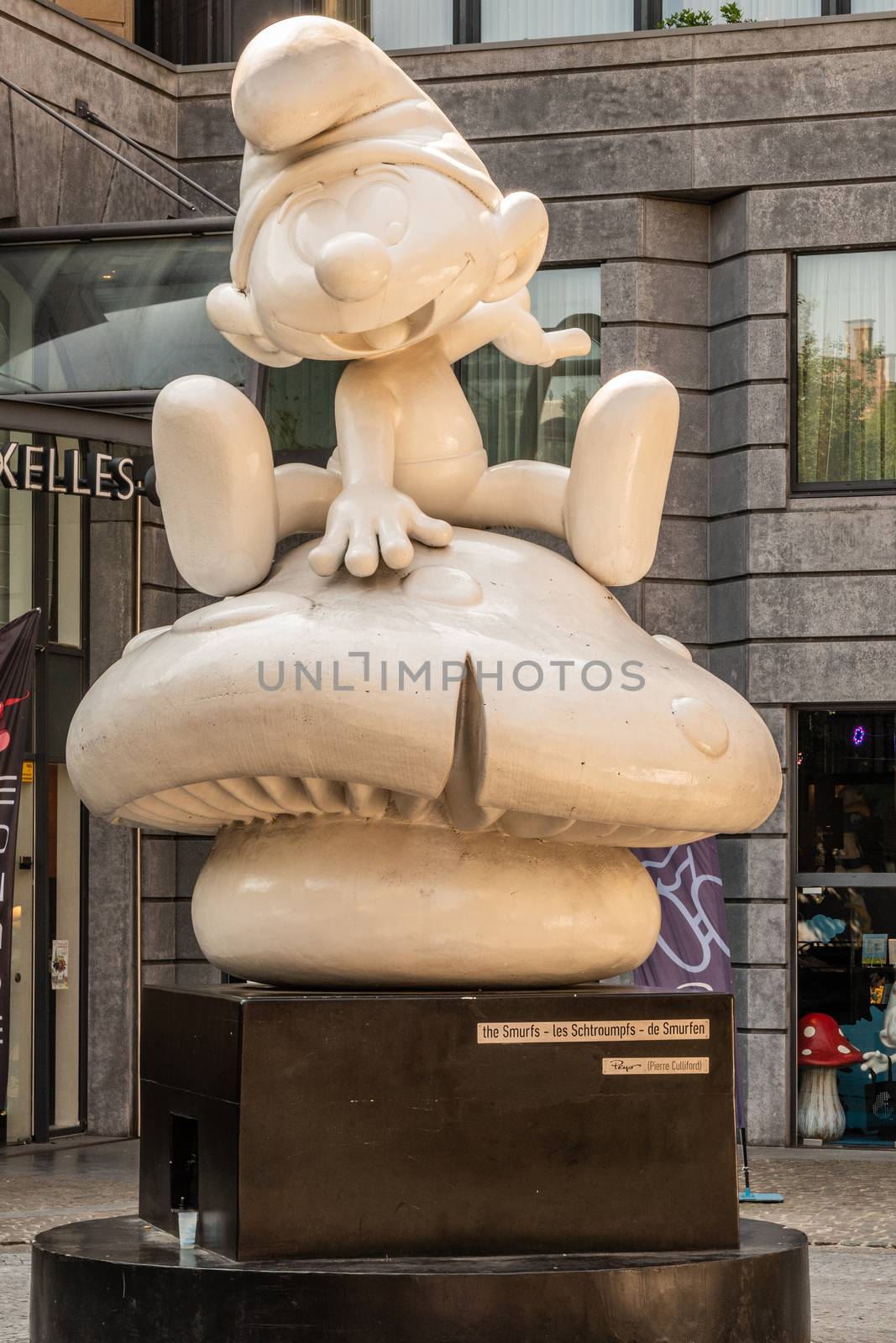 Brussels, Belgium - June 22, 2019: Large white statue of one Smurf on black pedestal in front of MOOF museum.