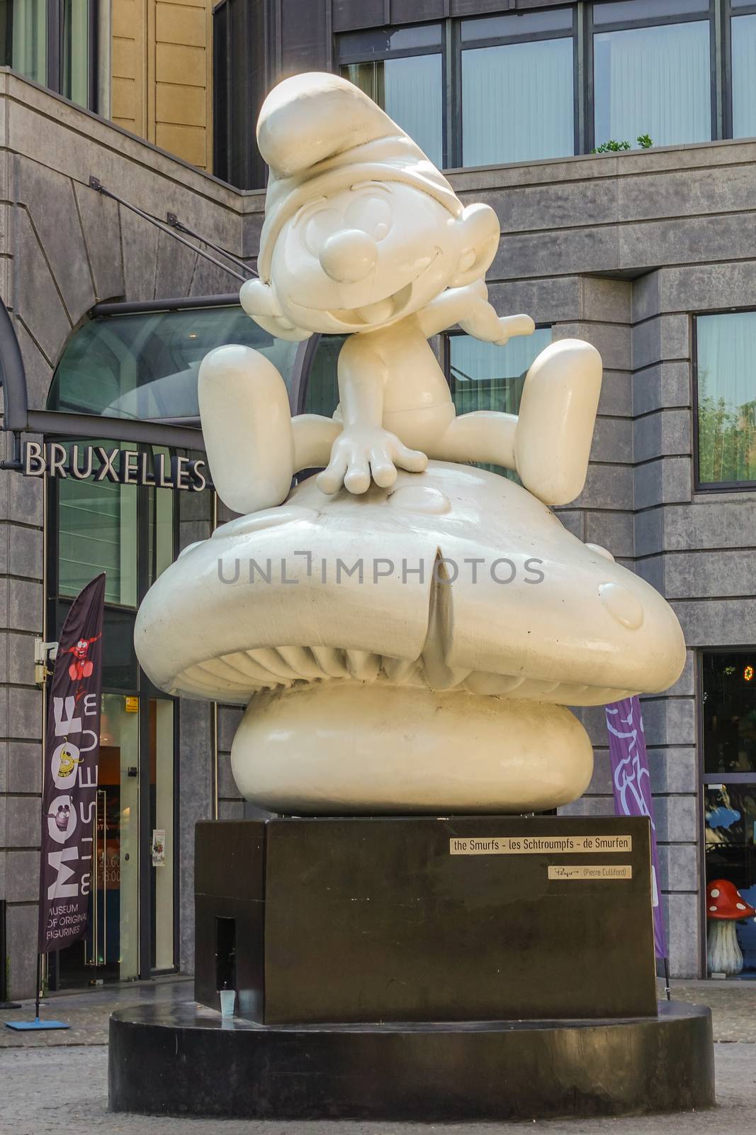 Brussels, Belgium - June 22, 2019: Large white statue of one Smurf on black pedestal in front of MOOF museum.