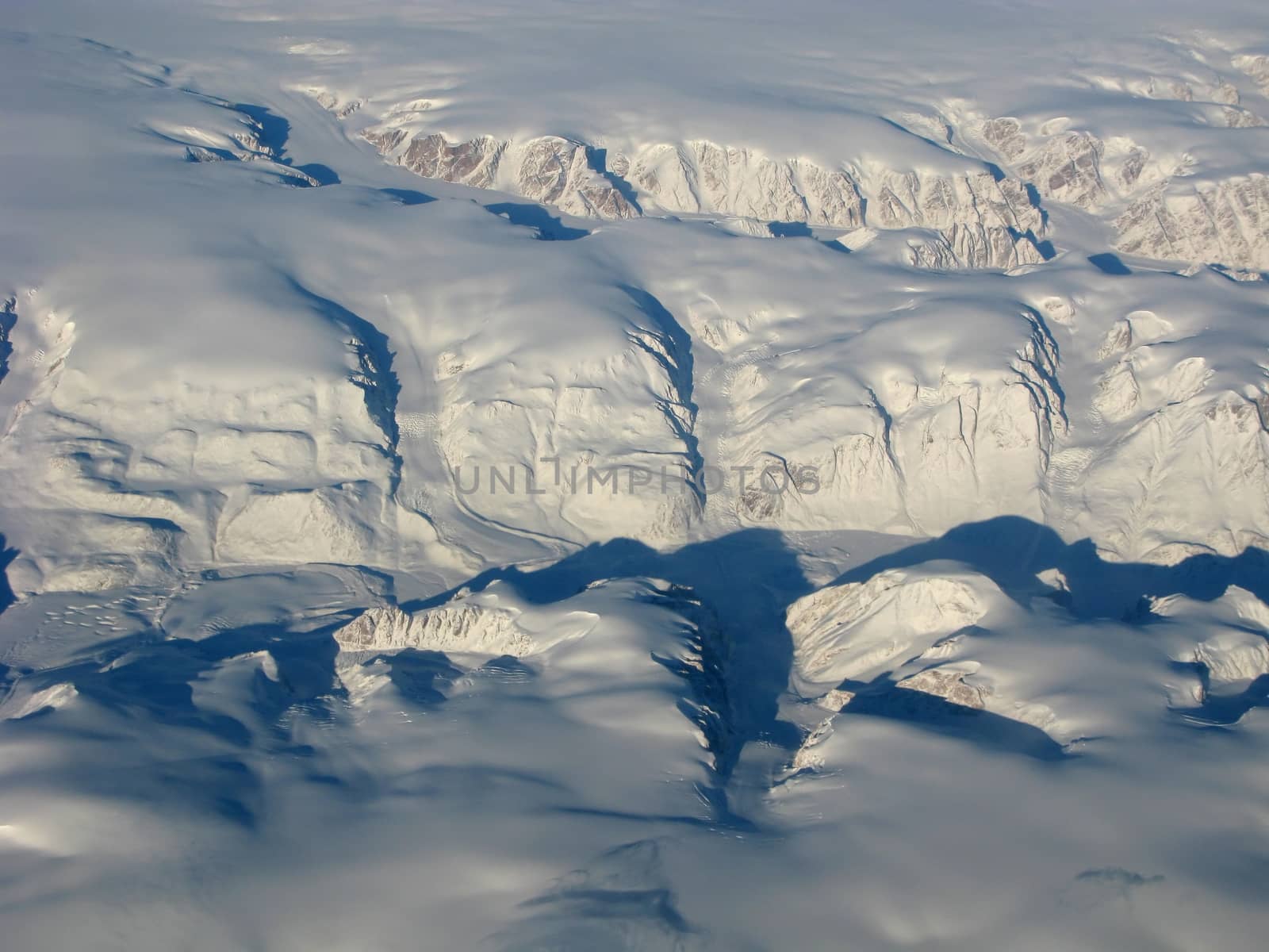 Aerial view of the Greenland glacier and mountains by nemo269