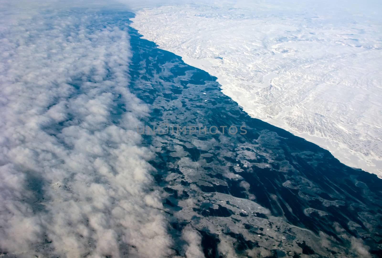 Aerial view of the Greenland coastline with ocean and clouds by nemo269