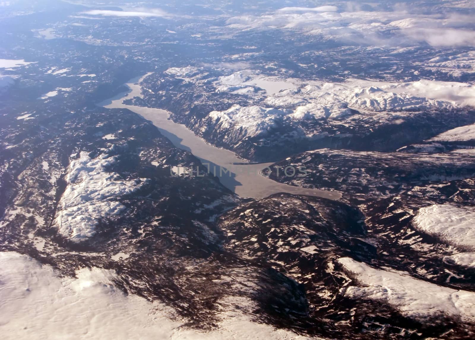 Aerial view of the distant scandinavian fiord, mountains and clouds