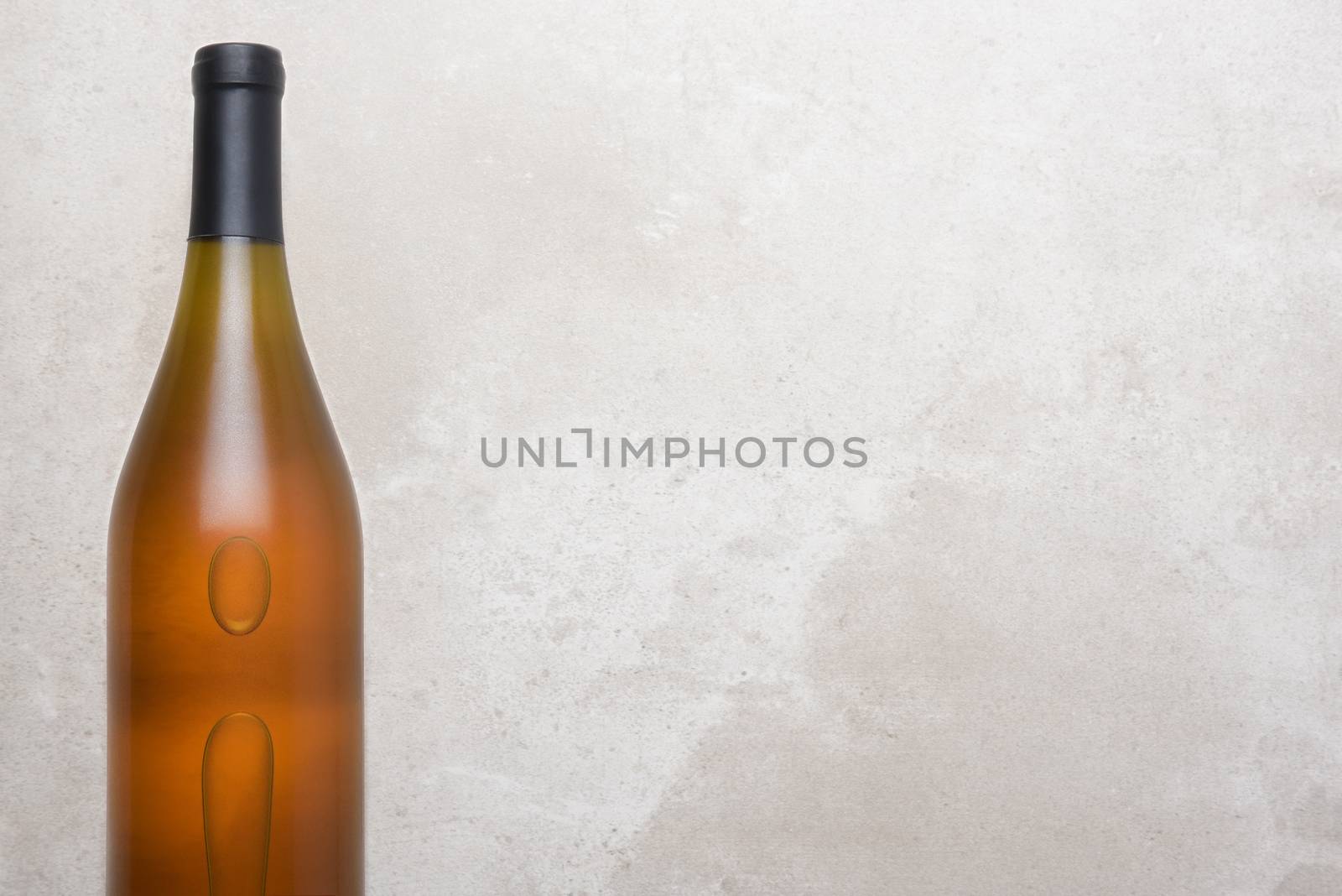 Chardonnay Bottle on a Concrete Table Top by sCukrov