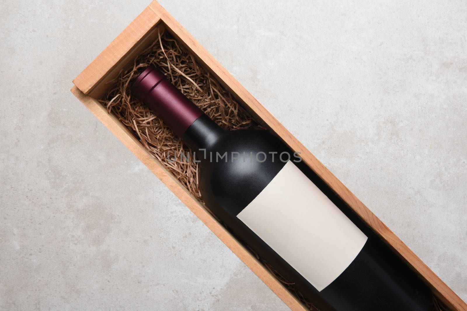 A single bottle of Cabernet wine in a wood case by sCukrov