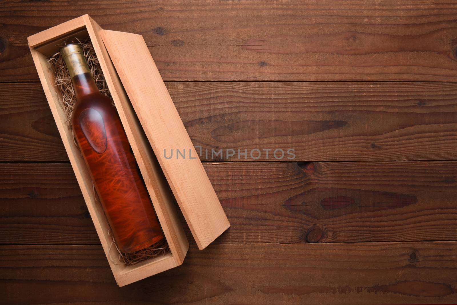 A single Bottle of Blush wine in its wooden case by sCukrov