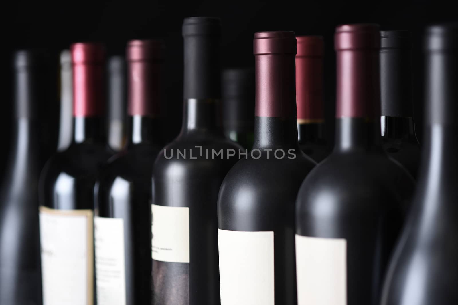 Row of vintage wine bottles in a wine cellar. Shallow depth of field. 