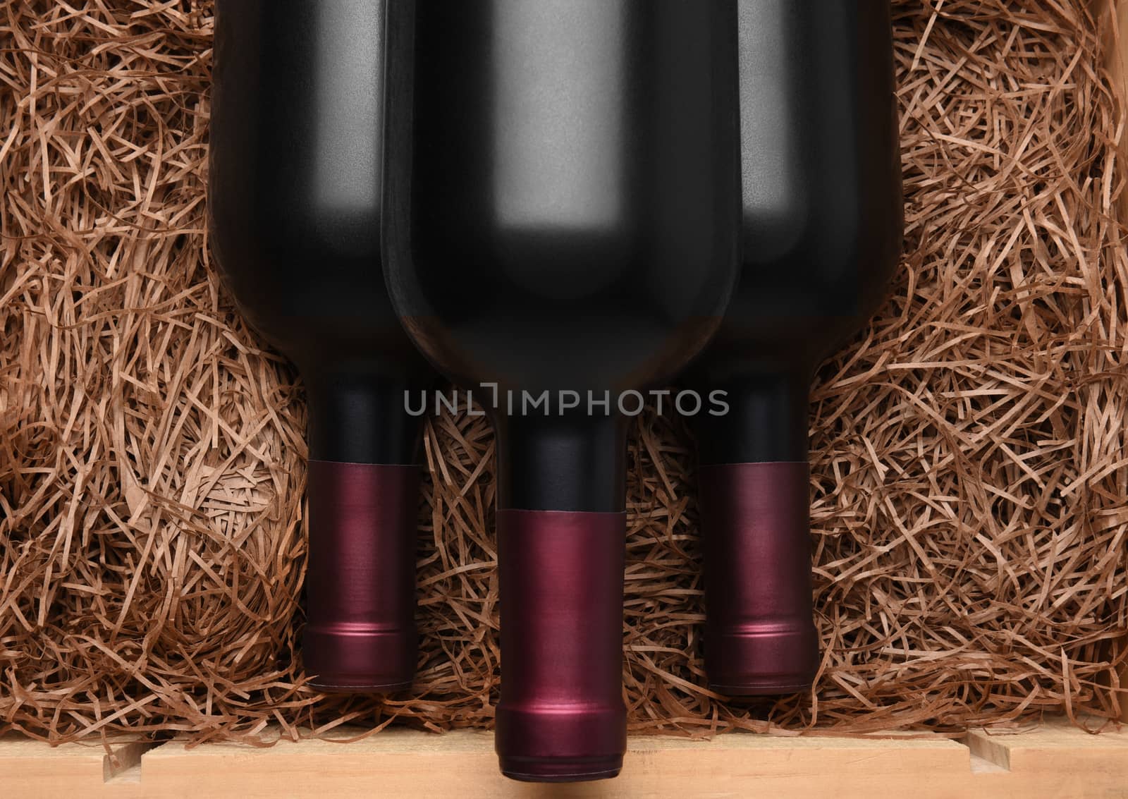 Three Bottles of red wine in a wood case by sCukrov